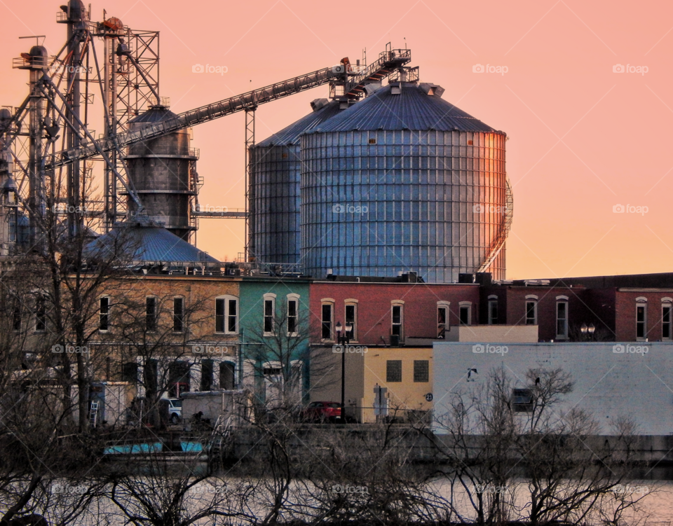 Michigan Riverside businesses, buildings and structures under a pink sunset evening sky