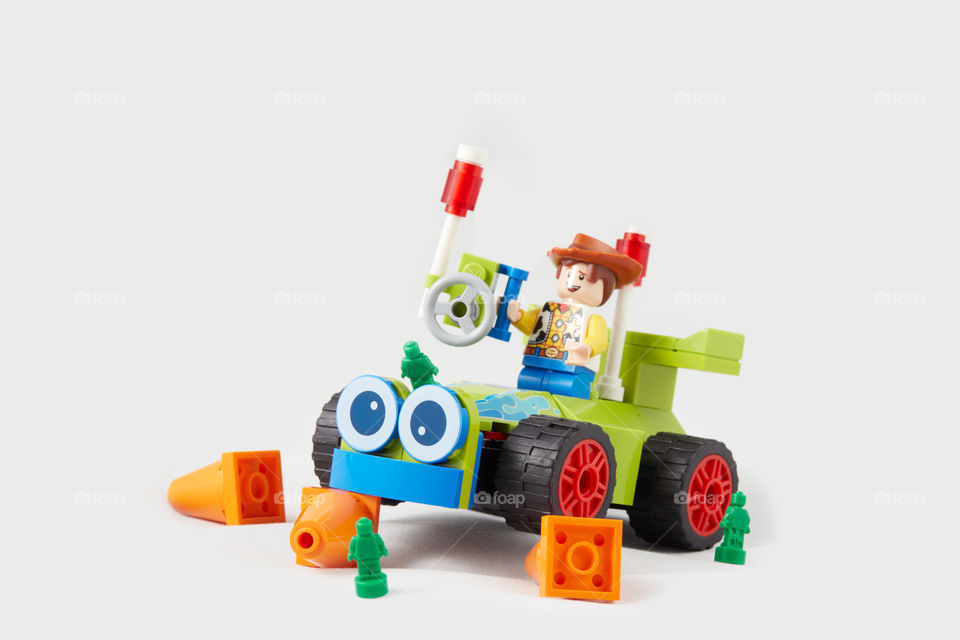 Woody driving a racing car. Lego figurines.