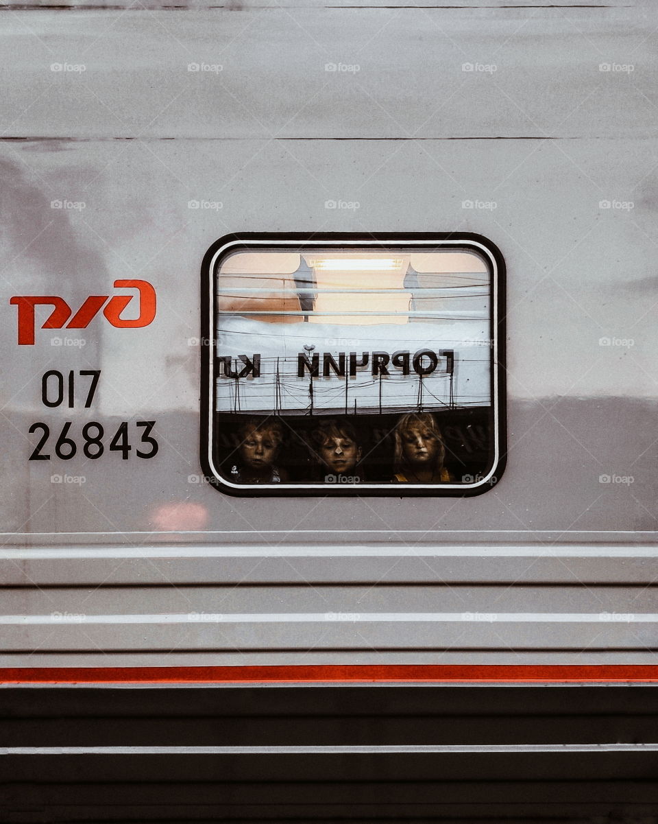 Children look out the train window