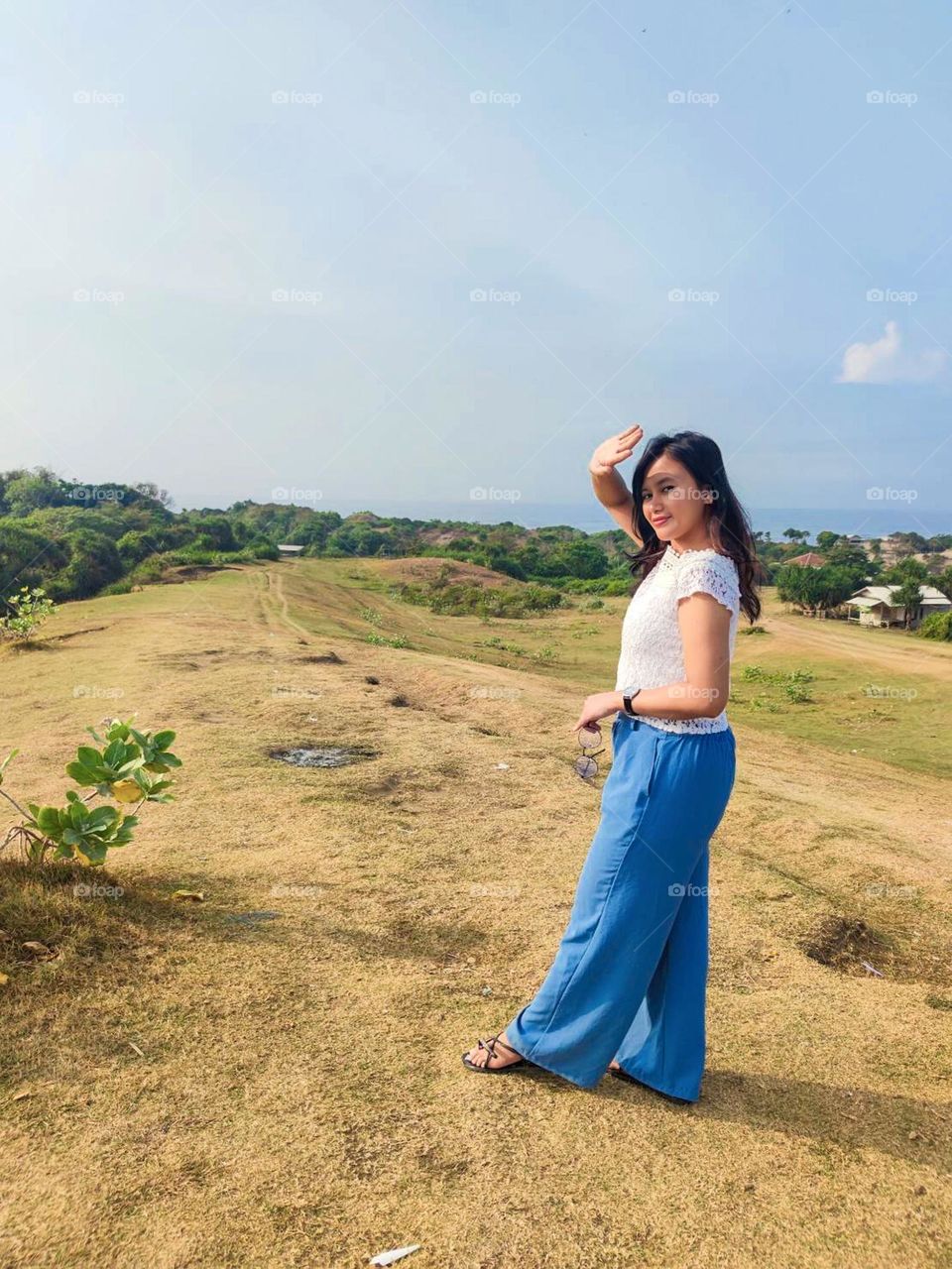 Portrait of young woman on holiday in the meadow during the day