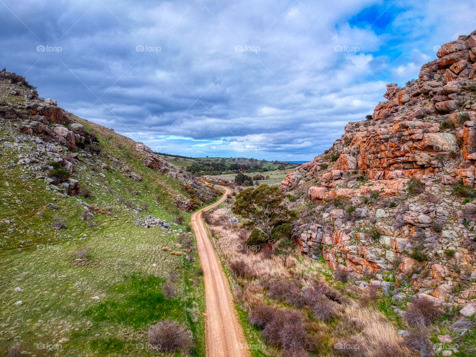 The Gap. A dirt road between two rocky hills. 