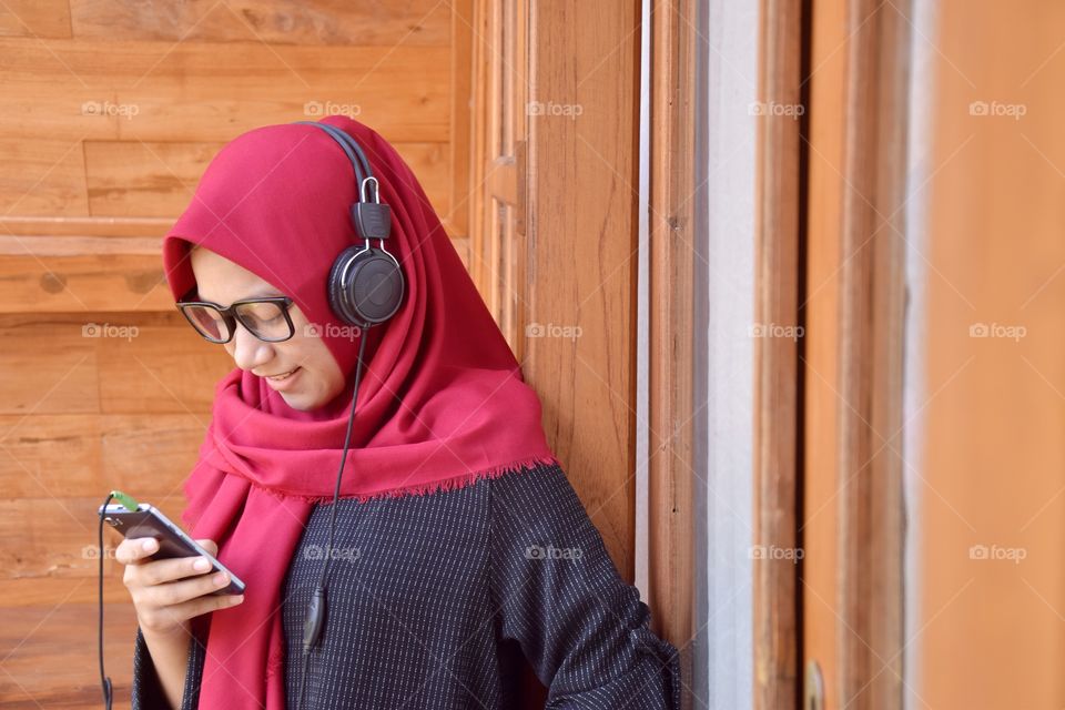 girl with mobile phone and headset headphone