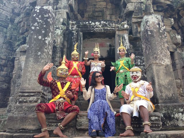 Young girl sitting with apsara dancer 