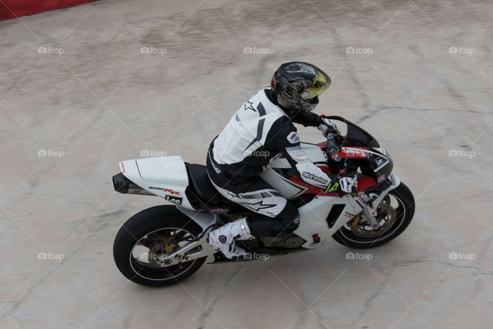 White sportbike and rider entering boxes 