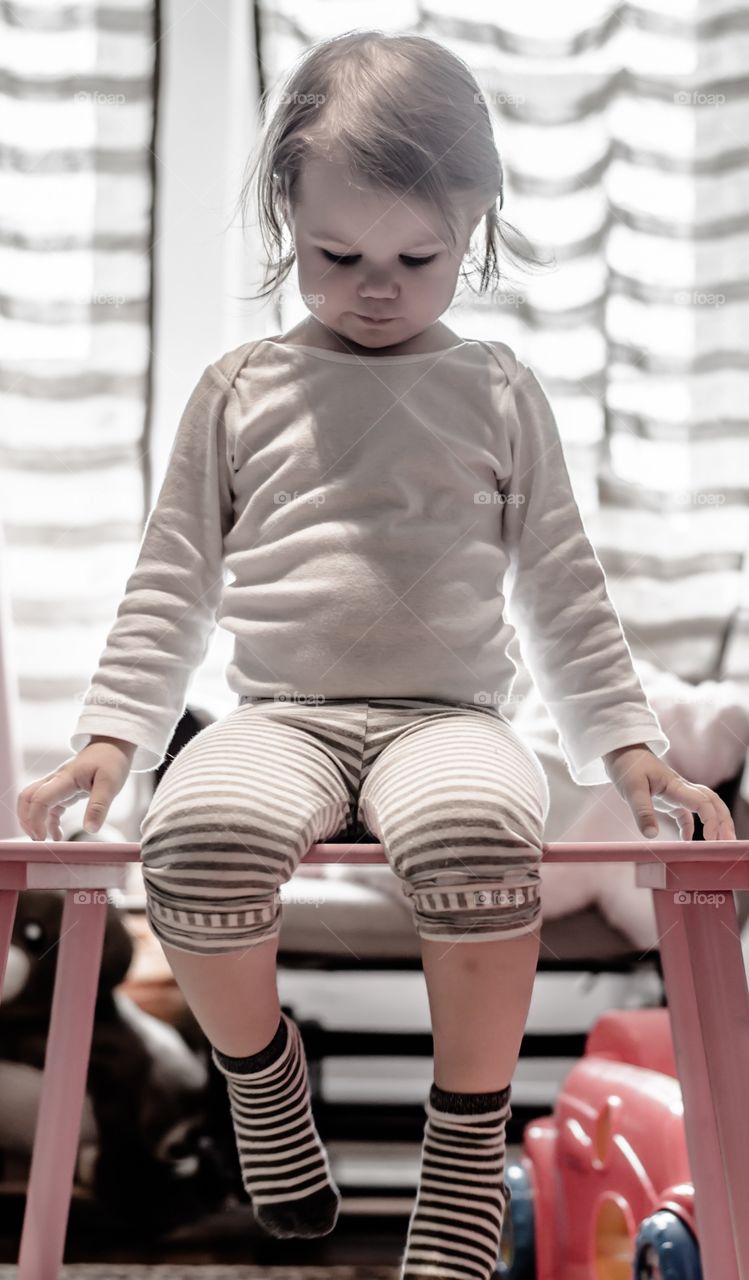 Girl sitting on wooden bench