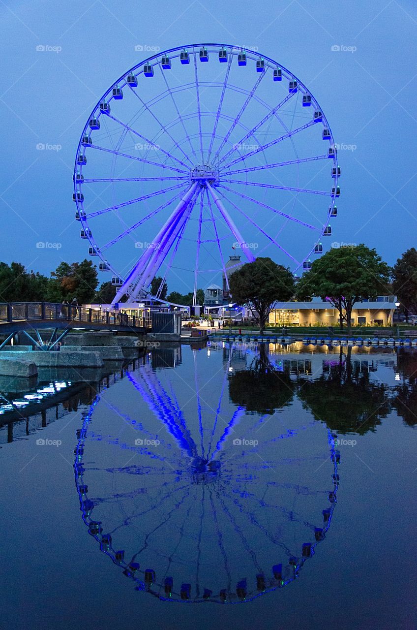 Ferris Wheel reflected in the water in Old Port of Montreal 