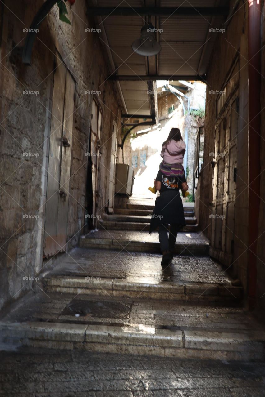 Old Nazareth lens little streets market place a boy take a girl on his shoulders 