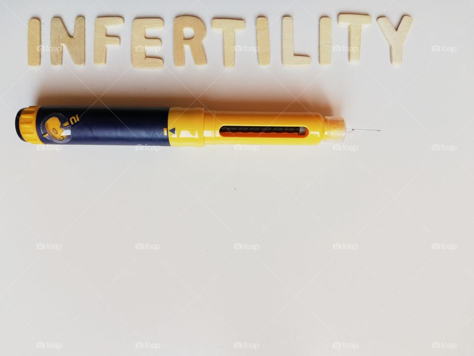 Written: infertility and pen to make punctures on the belly