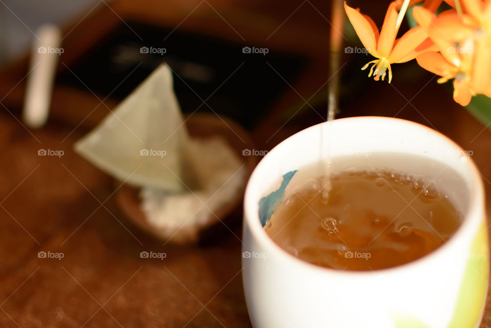 Close-up of pouring tea into cup