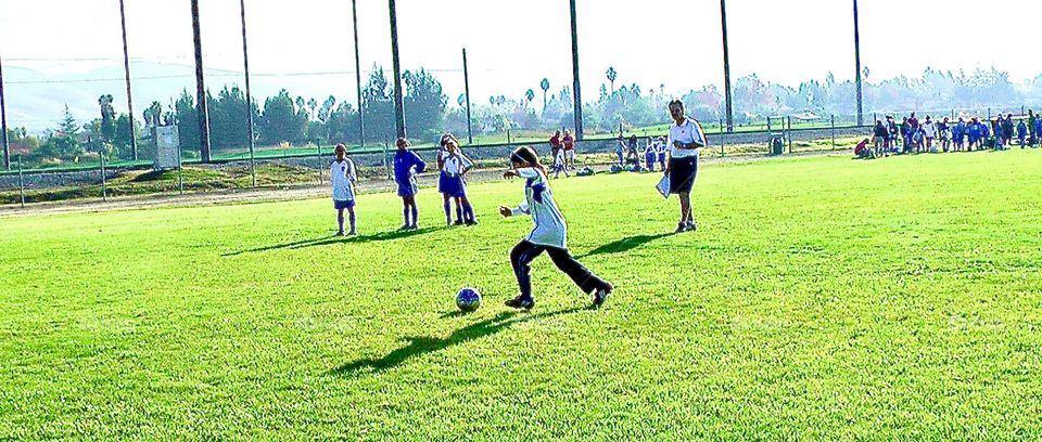 Children playing soccer at a high school match