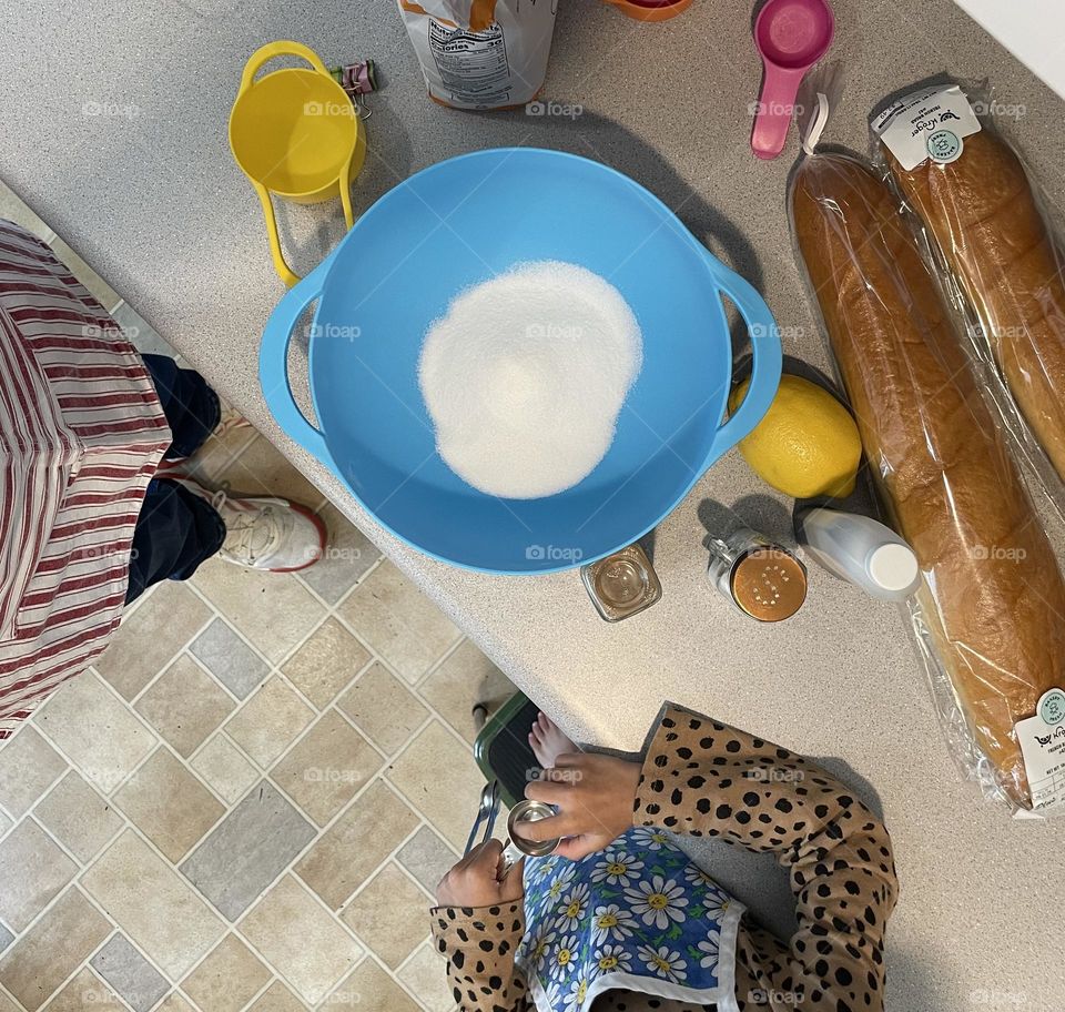 Making bread pudding, delicious desserts at home, baking with toddlers, baking from scratch, over head view of countertop 