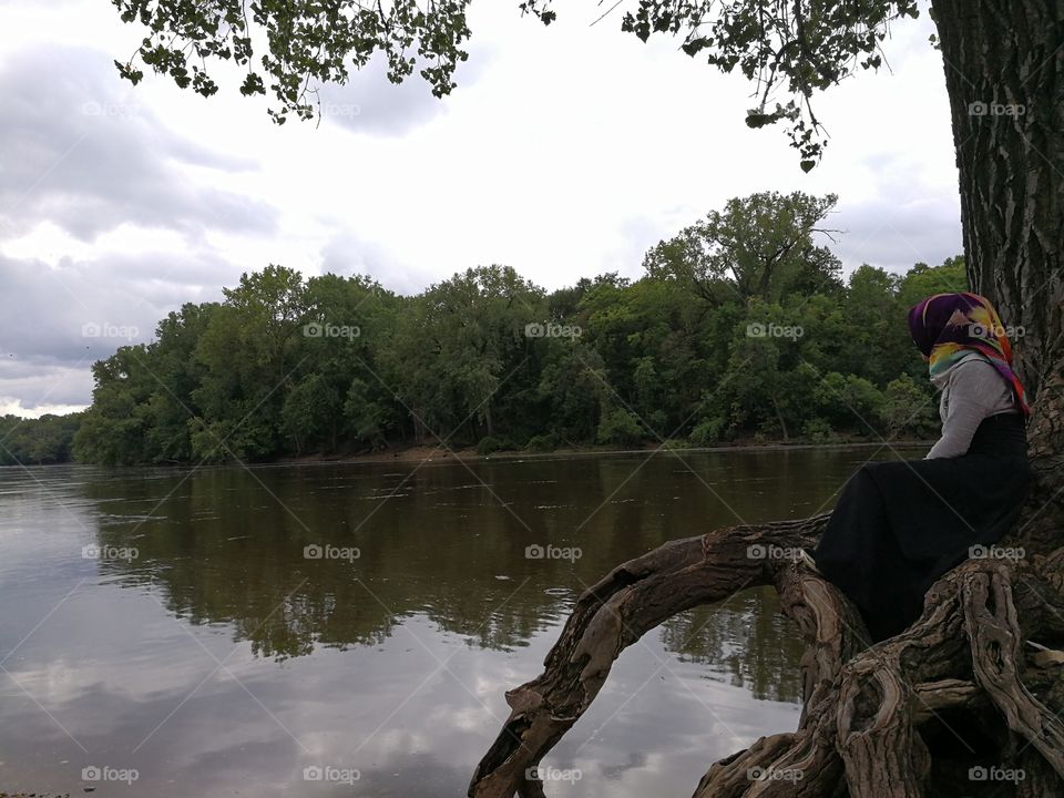 sitting on the roots of the old tree and looking at the lake, just think your life