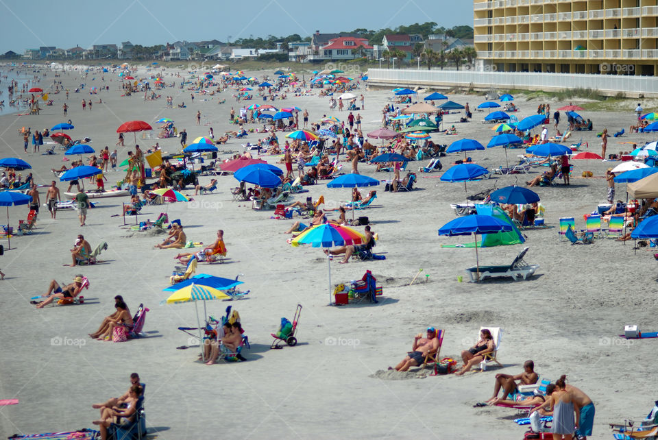 Busy Beach with Many People and Umbrellas 