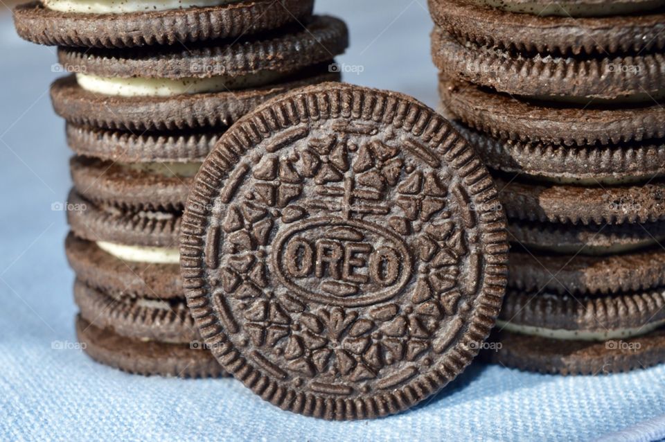 A stack of Oreo cookies on a blue background