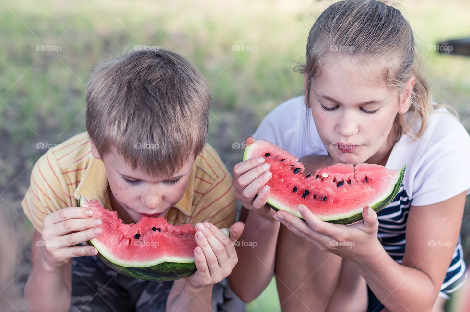 Kids eating watermelon