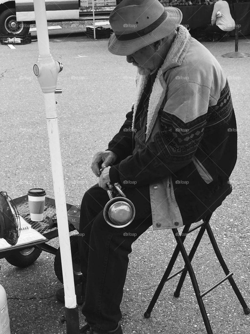 Musician resting at Farmers Market on a Saturday 