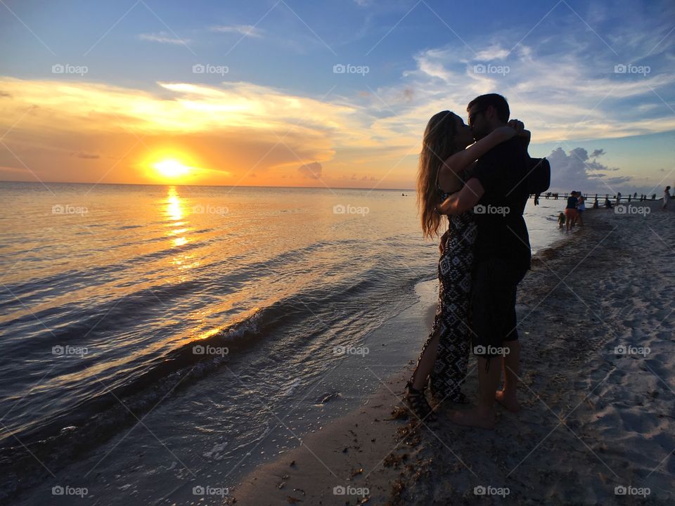 Silhouettes couple lovers sea ocean Seaside sunset 