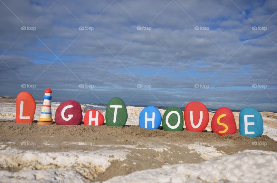 Lighhouse concept on colourful stones