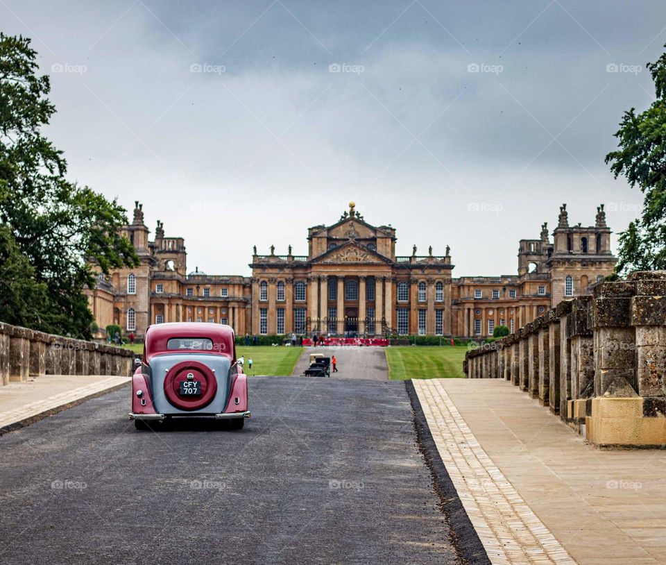 Old car and palace in the background.