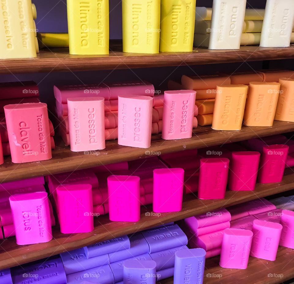 Variety of soaps on wooden shelf