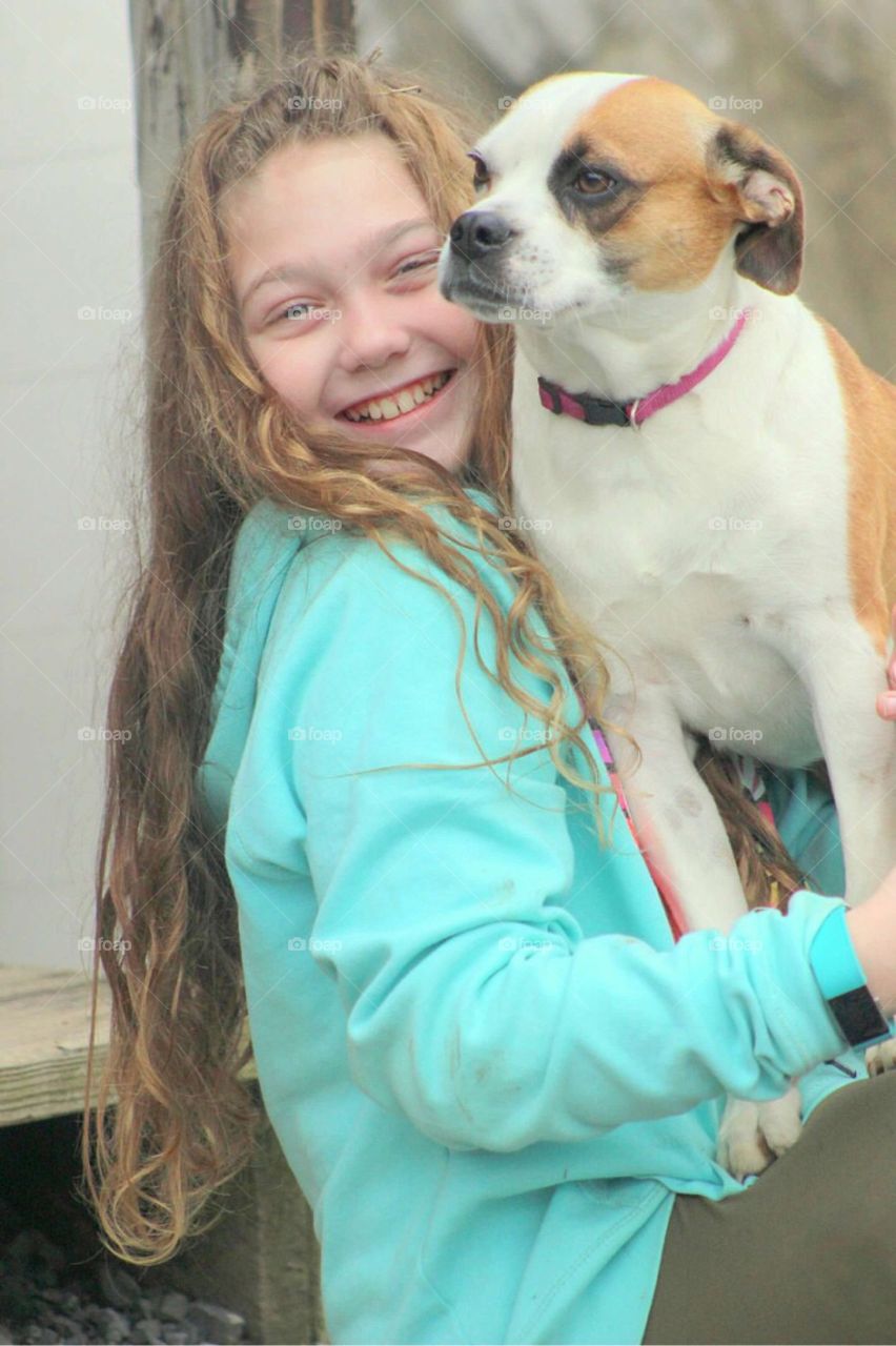 Close-up of a smiling girl with dog