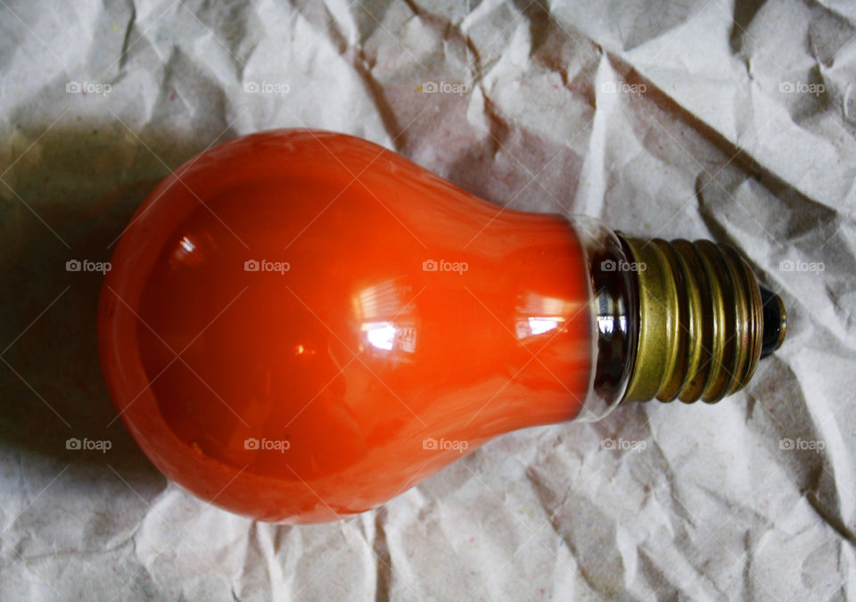 An orange bulb on a paper background 3