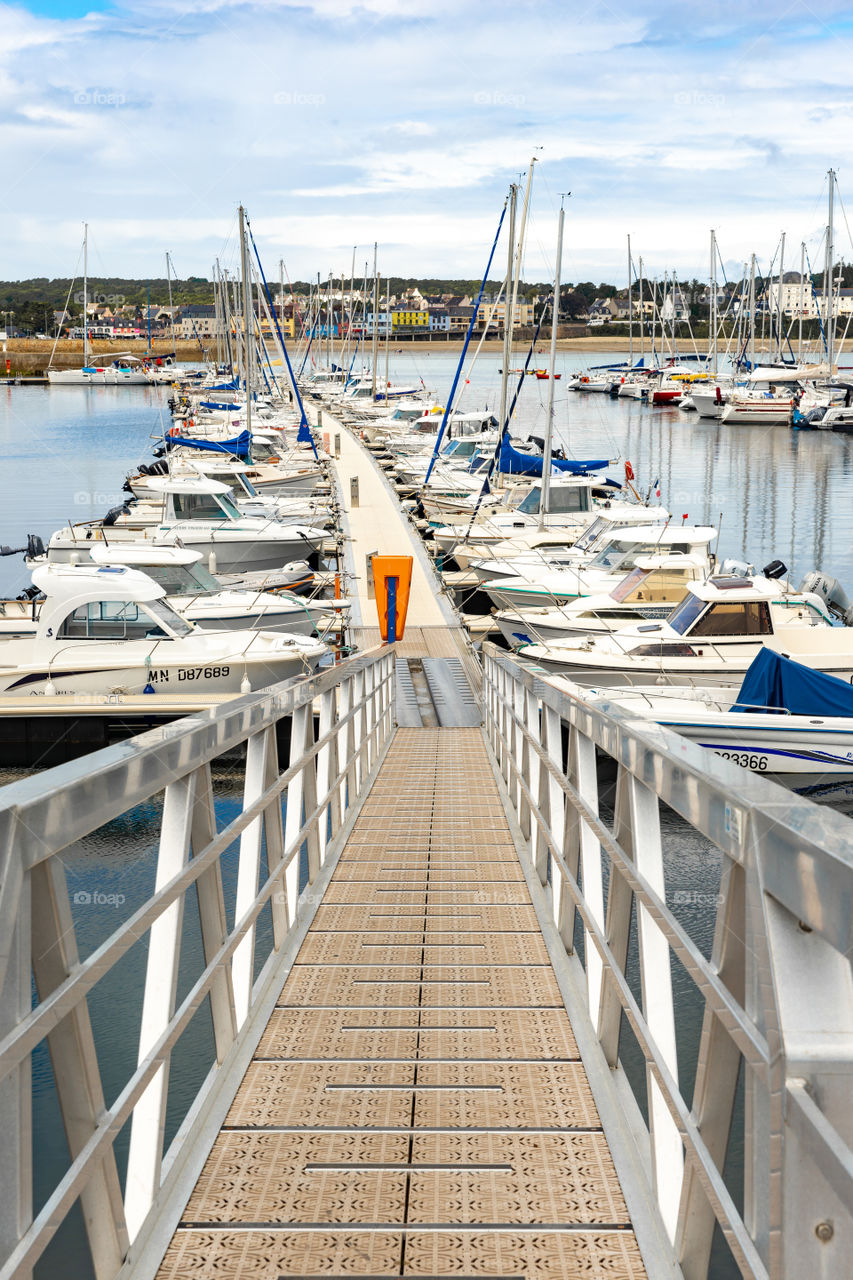 footbridge in a port and sailing ships
