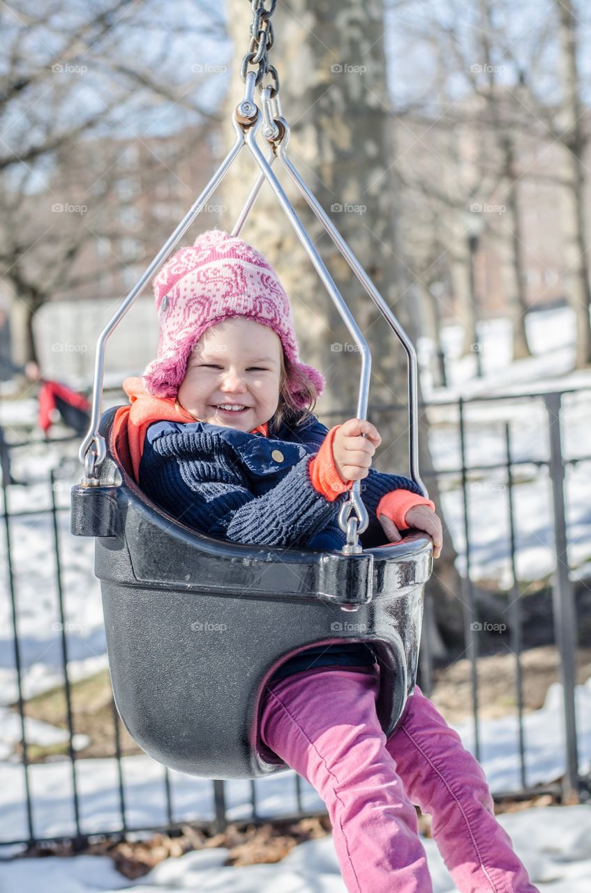 Girl sitting on swing