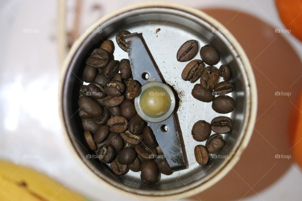 coffee beans in a coffee grinder