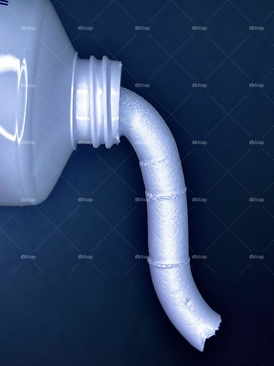 Squeezing cream out of a tube. Close-up.