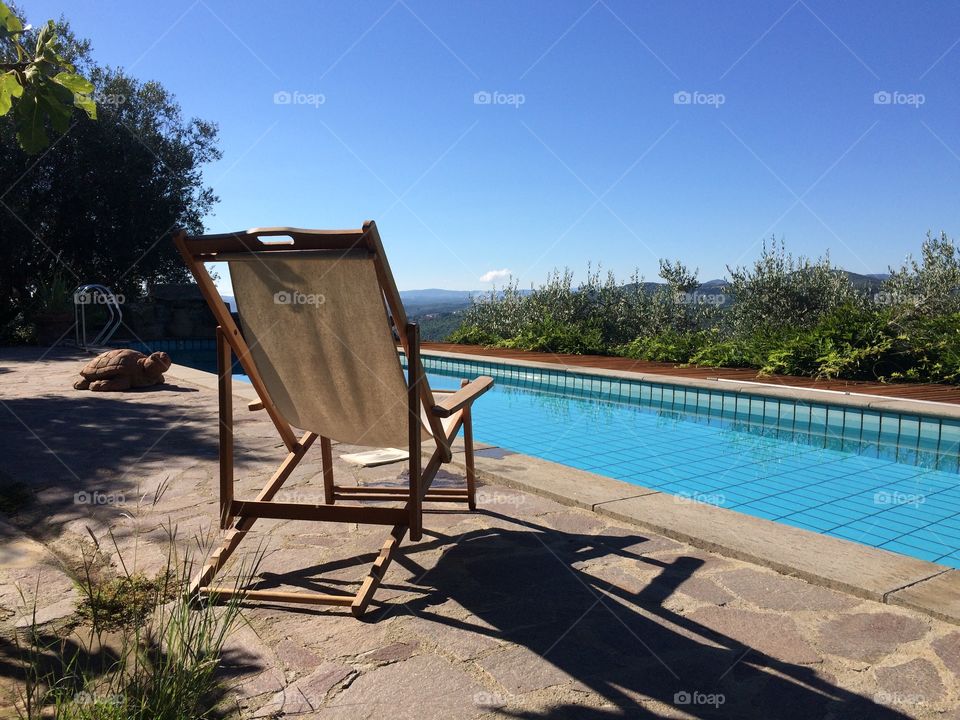 Chair in front of a pool. Our holiday vacation