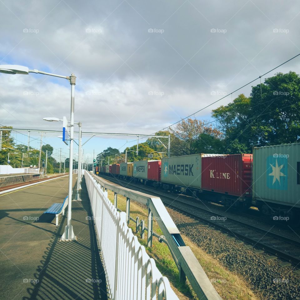 a freight train passing through Hurlstone Park train station. Sydney, Australia