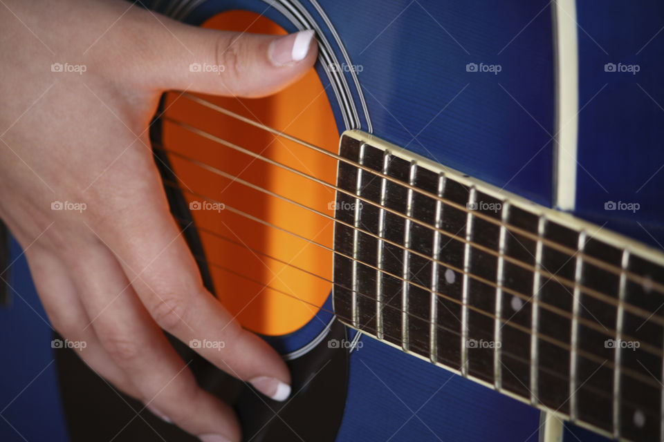 Hand on a blue Guitar