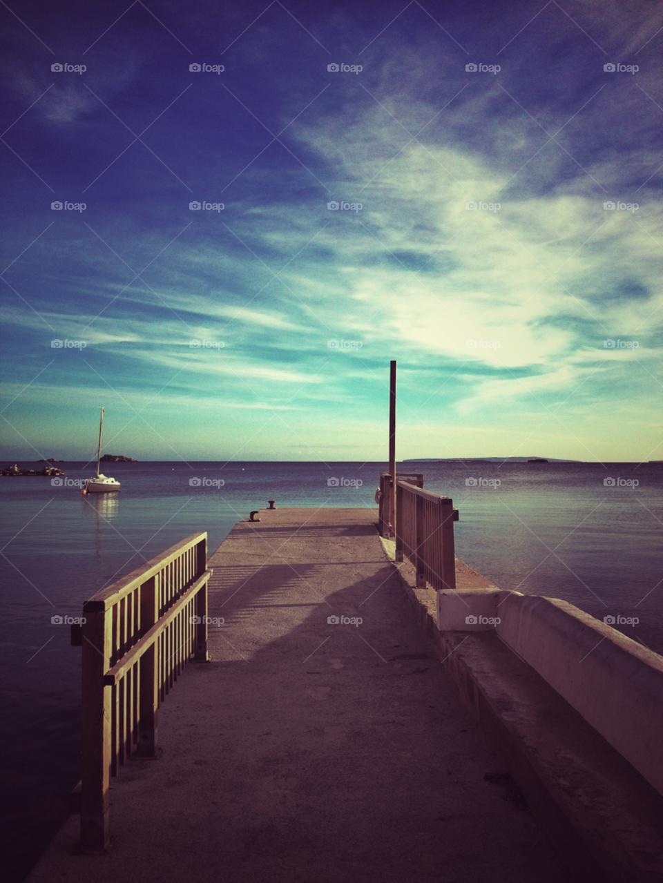 Pier against cloudy sky