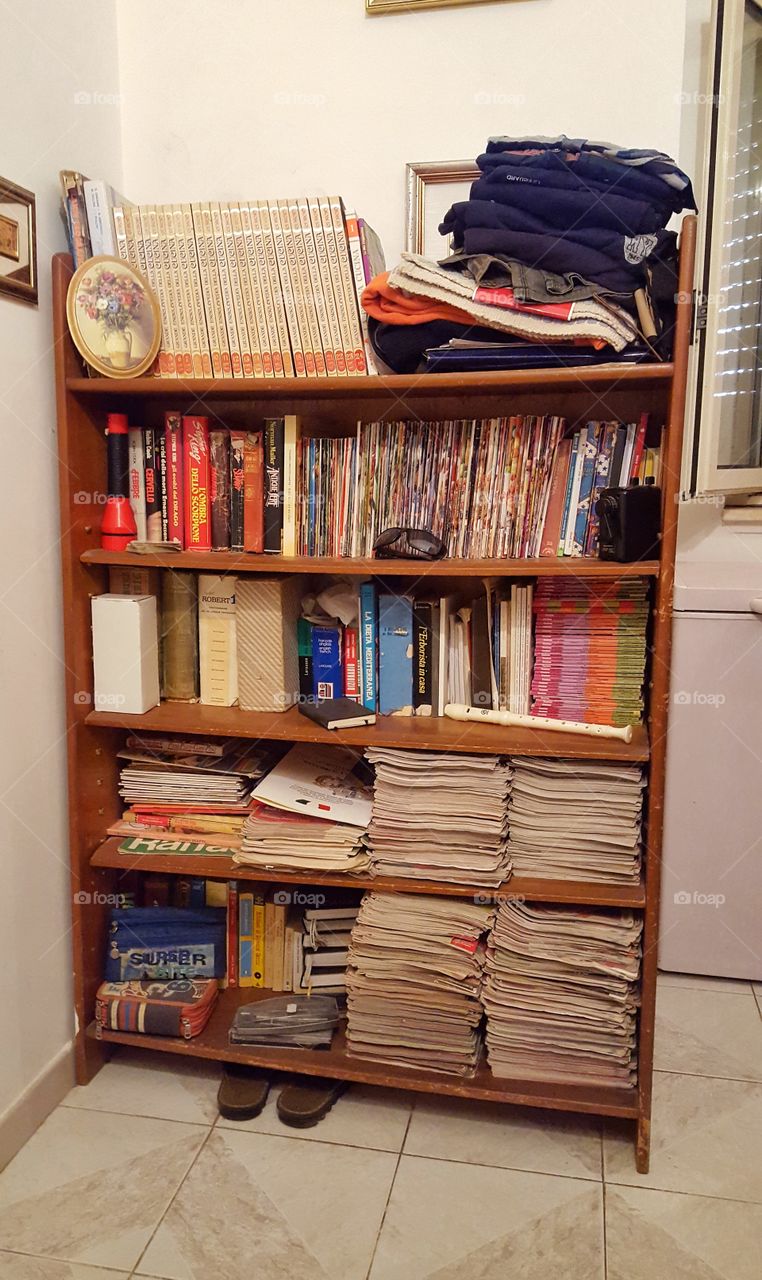 shelf full of books and objects forgotten by time