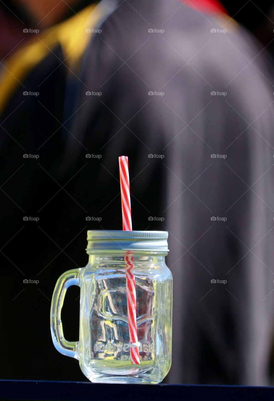 Single mason jar glass with straw, minimalist image 