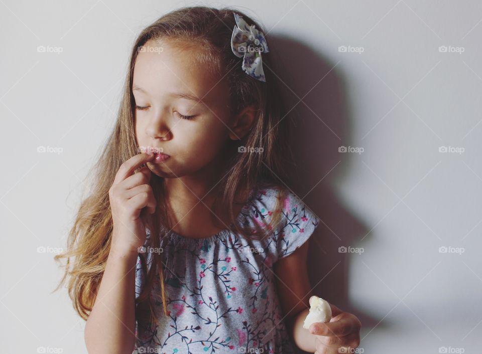 Little girl eating coconut candy