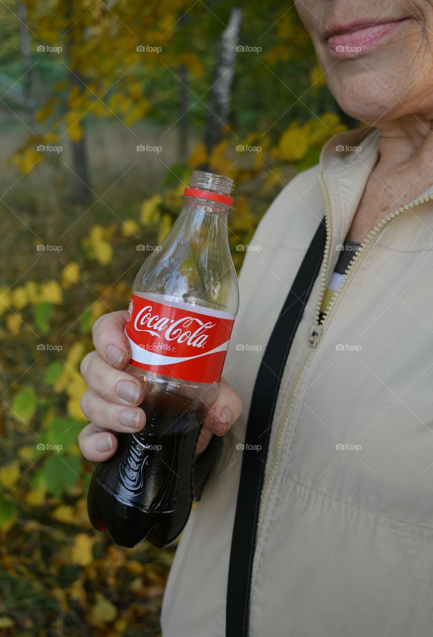 coca cola in hand female old