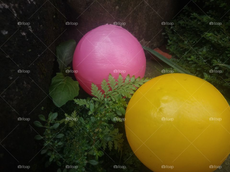 pink and yellow plastic ball