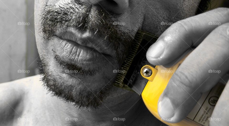 Close-up of man with trimmer