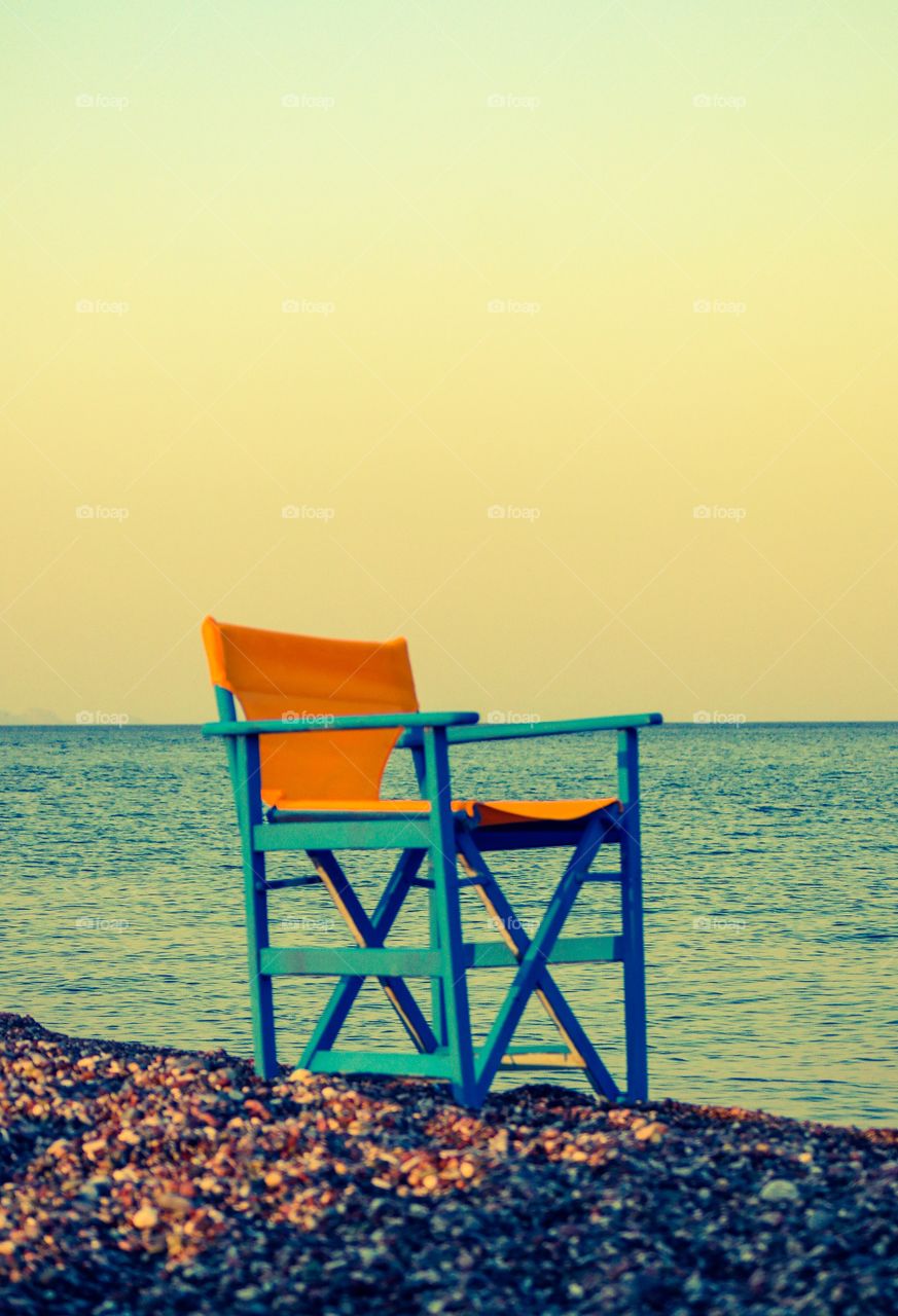 The best seat in the world. A chair is waiting in front of the sea