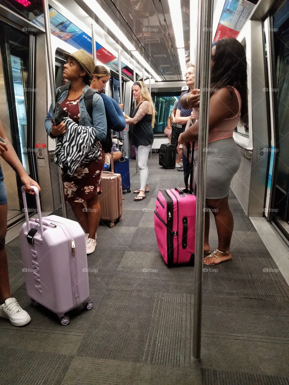 People riding the tram to gate for flight