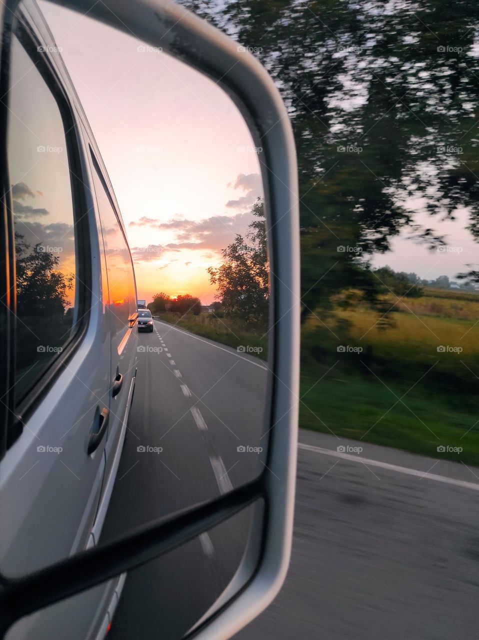 sunset reflected in the car mirror
