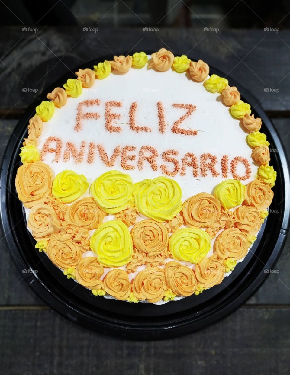 Happy anniversary cake with yellow and orange flowers