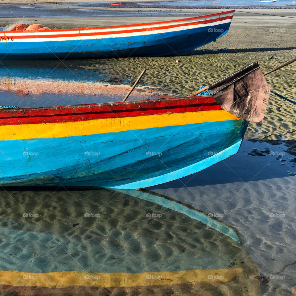 Two coloured boats in the beach 