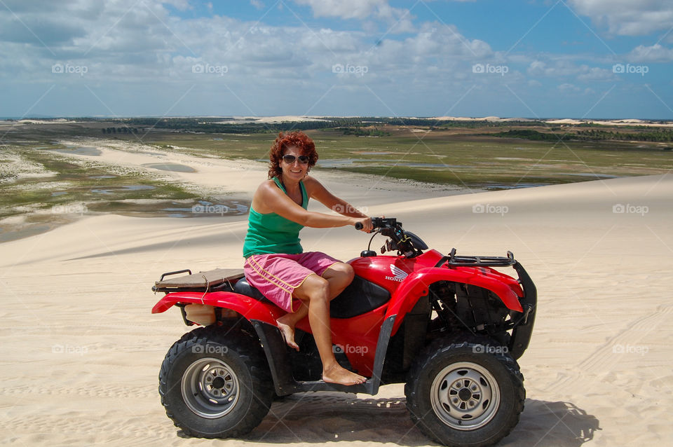 Woman driving quad in the desert 
