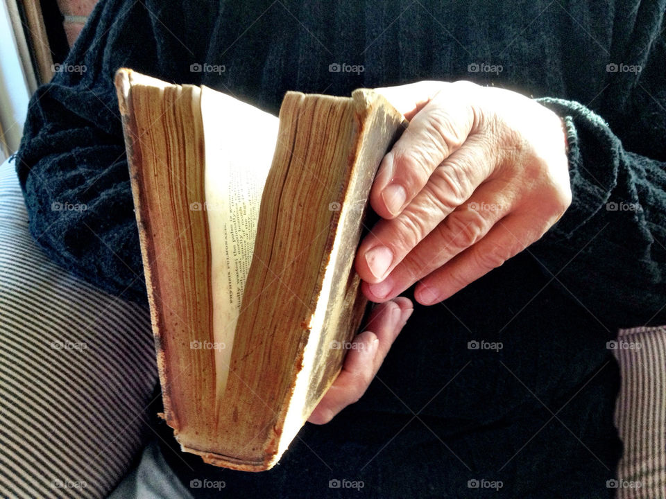 Man holding very old book