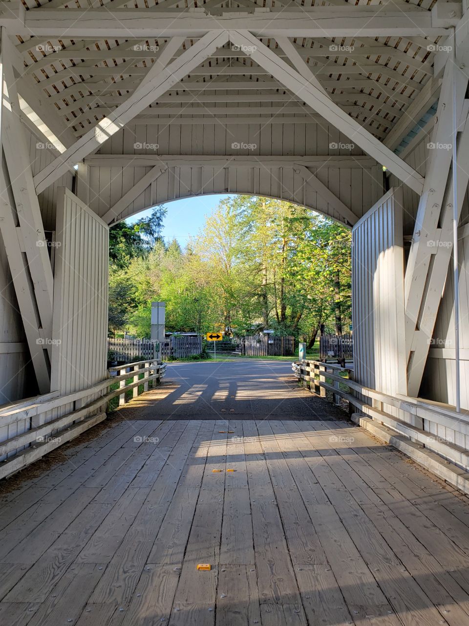 The view from inside a short covered bridge in Western Oregon on a sunny spring day. 