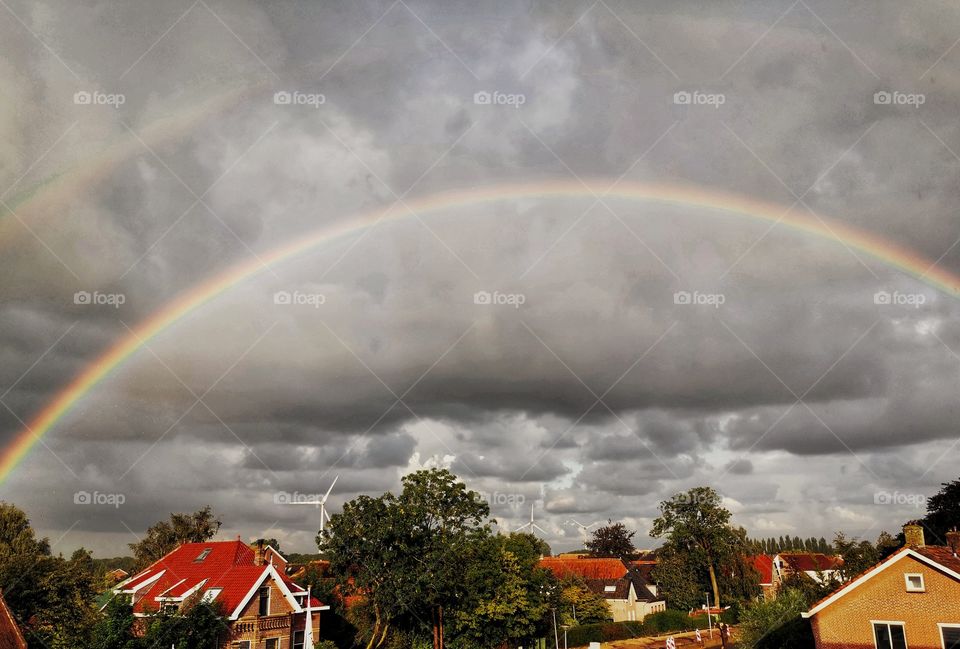 Draw a double rainbow over a cloudy day