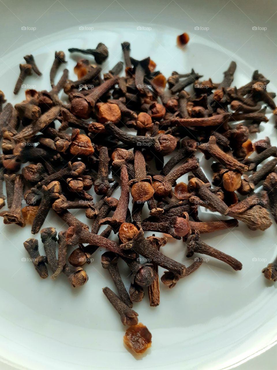 Cloves are the aromatic flower buds of a tree in the family Myrtaceae, Syzygium aromaticum. They are native to the Maluku Islands in Indonesia, and are commonly used as a spice. 
